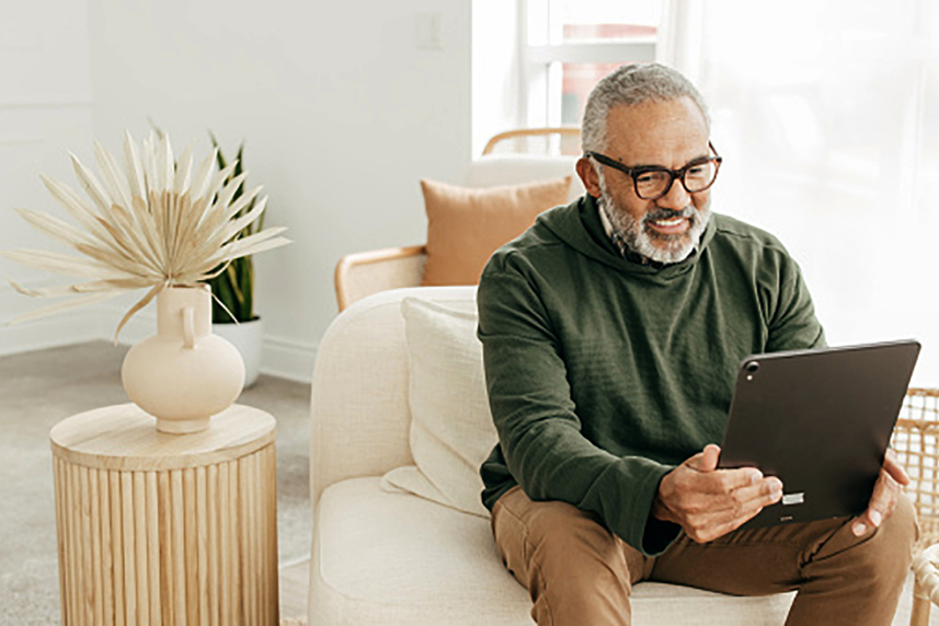A man looking at a tablet.