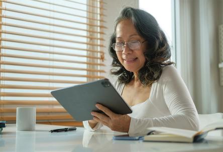 A senior looks at a tablet computer