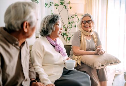 A group of older people sitting and talking.