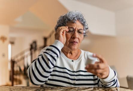 A woman looking at a prescription.