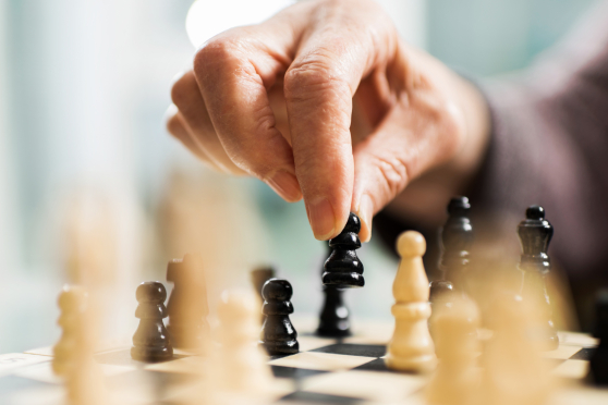 A hand moving a chess piece.
